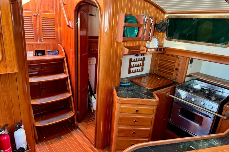 Slide: The Image of Interior of 1988 Hans Christian Christina sailboat with wooden cabinetry and compact kitchen. - 16