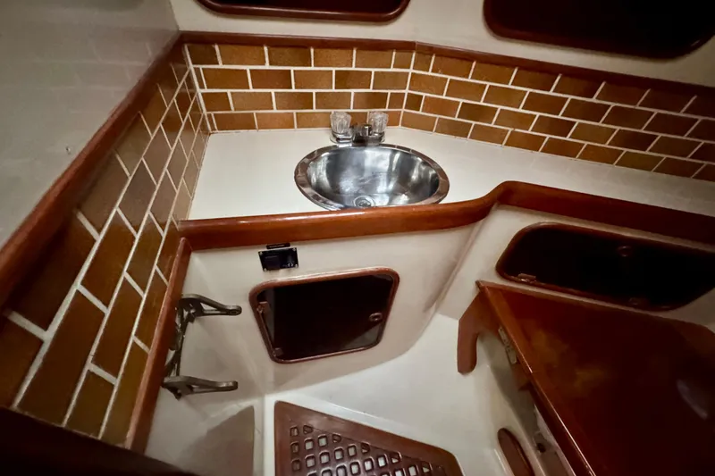 Slide: The Image of 1988 Hans Christian Christina yacht bathroom with sink, wooden accents, and tiled walls. - 23