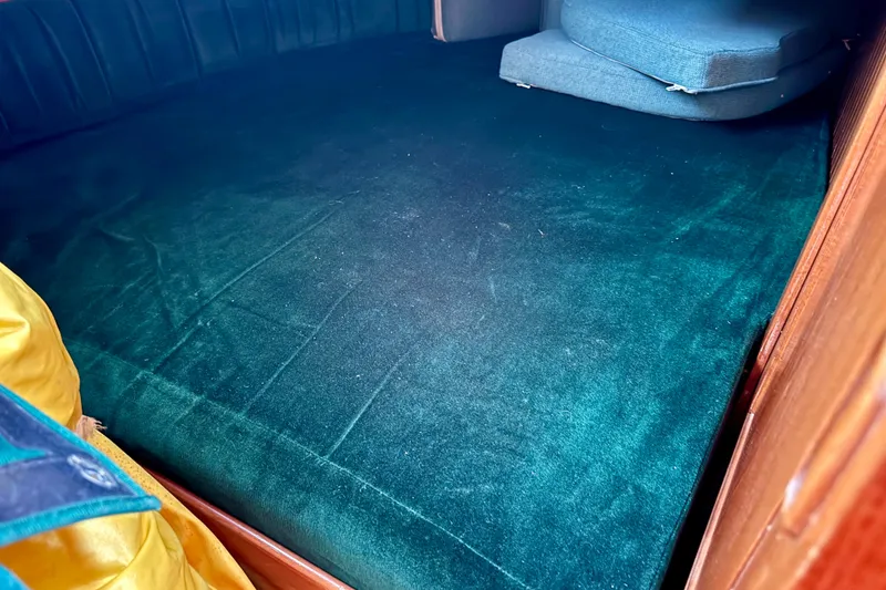 Slide: The Image of Interior cabin of 1988 Hans Christian Christina with green upholstery and cushions. - 26