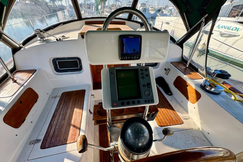 Slide: The Image of Cockpit of 1988 Hans Christian Christina sailboat with navigation equipment and wooden seating. - 28