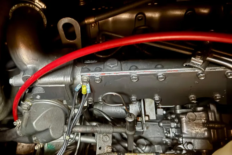 Slide: The Image of Engine components of a 1988 Hans Christian Christina, featuring red wiring and metallic parts. - 35