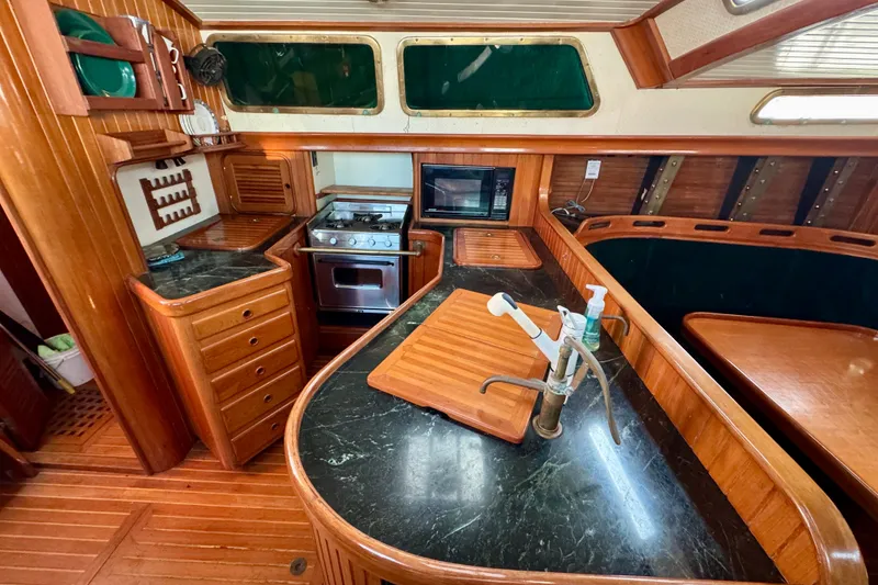 Slide: The Image of Luxurious 1988 Hans Christian Christina yacht kitchen with wood cabinetry and modern appliances. - 6