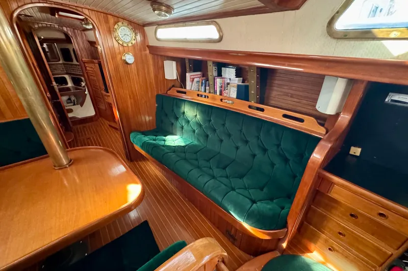 Slide: The Image of Interior of 1988 Hans Christian Christina yacht with green seating and wooden finishes. - 8