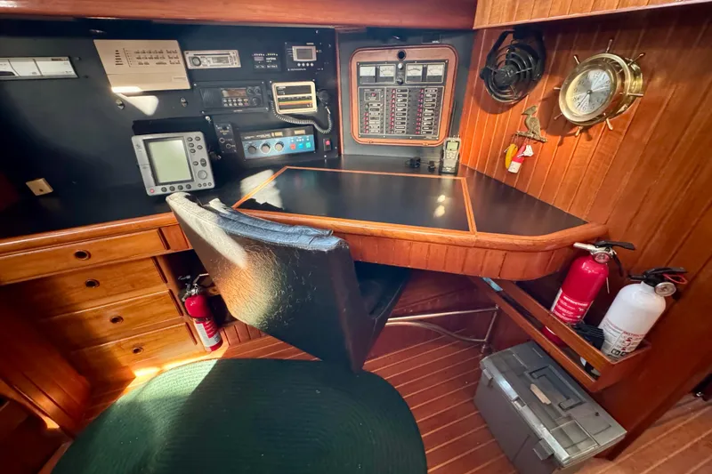 Slide: The Image of Navigation station on 1988 Hans Christian Christina yacht with control panels and equipment. - 9