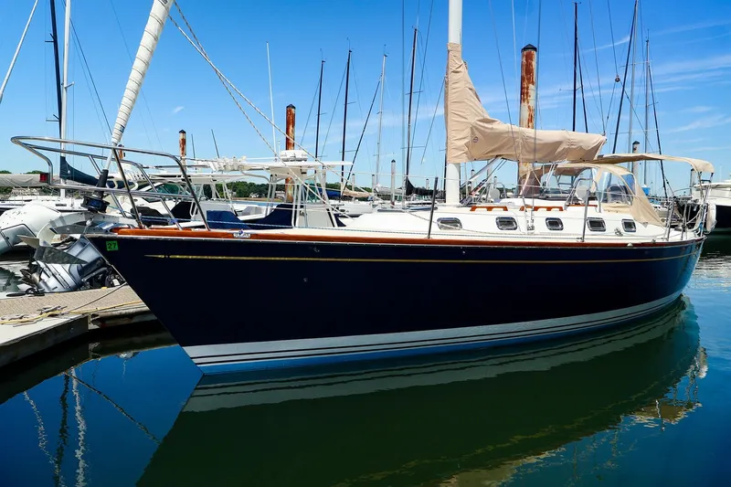 The Image of Sailboat docked at marina, Tartan 3500 model, 1999, with blue hull and beige covers. - 0