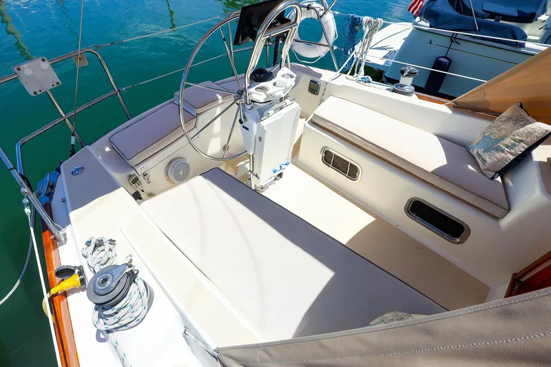 Slide: The Image of Cockpit of 1999 Tartan 3500 sailboat with steering wheel and seating. - 12