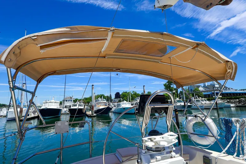 Slide: The Image of Sailboat Tartan 3500 (1999) docked at marina under clear blue sky. - 13