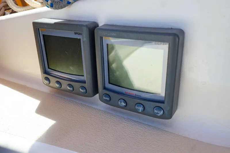Slide: The Image of Digital speed and depth gauges on a 1999 Tartan 3500 yacht dashboard. - 16