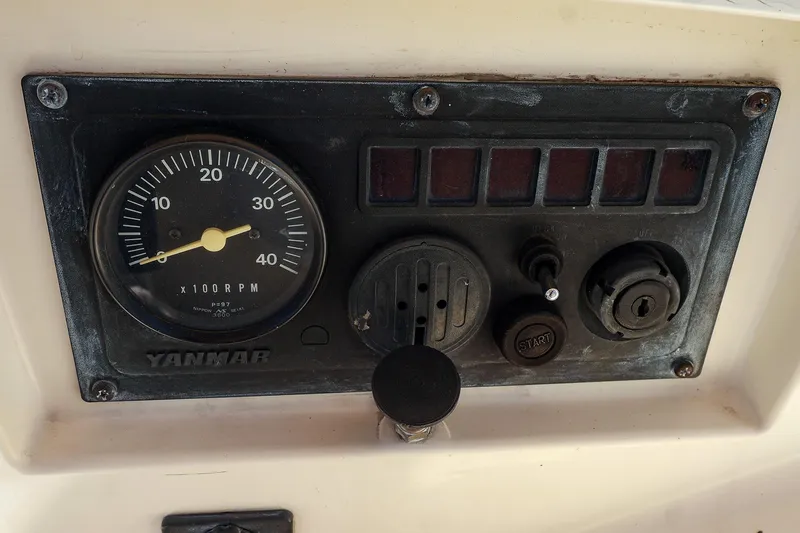 Slide: The Image of Control panel of a 1999 Tartan 3500 with Yanmar tachometer and ignition switch. - 18