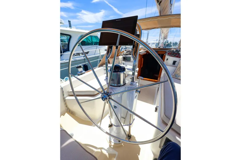 Slide: The Image of Steering wheel of a 1999 Tartan 3500 sailboat under a clear blue sky. - 2
