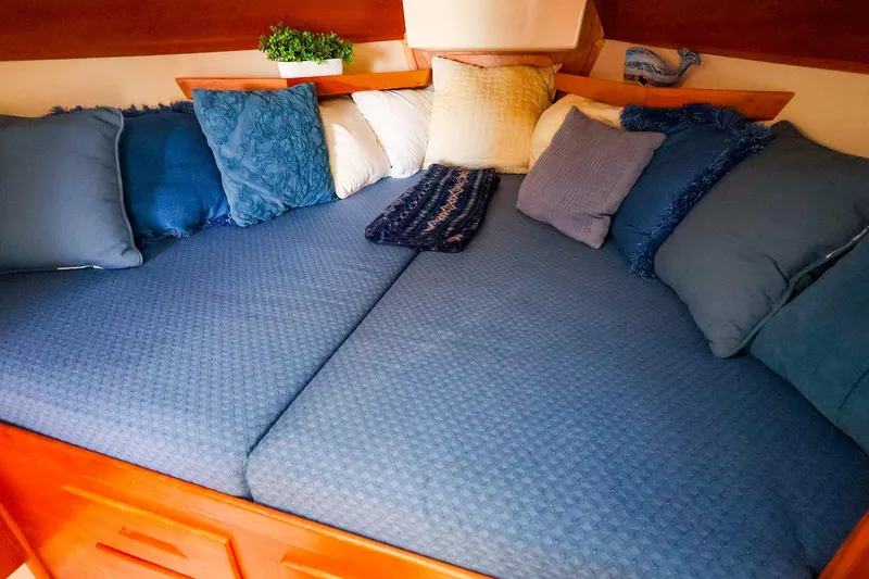Slide: The Image of Cozy cabin bed with blue cushions in a 1999 Tartan 3500 sailboat. - 29