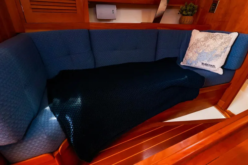 Slide: The Image of Cozy interior of 1999 Tartan 3500 sailboat with blue seating and decorative pillow. - 30