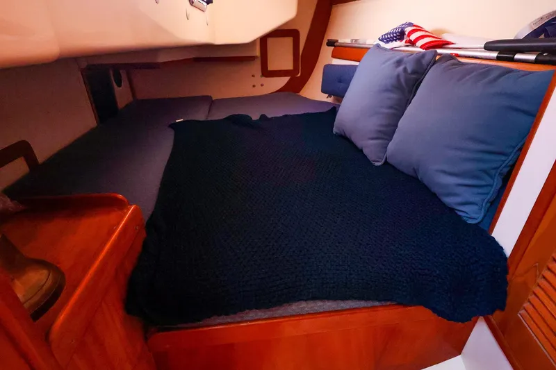 Slide: The Image of Cozy cabin interior of a 1999 Tartan 3500 sailboat with cushions and blanket. - 31