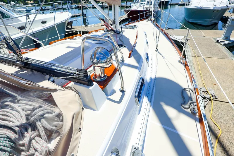 Slide: The Image of Sailboat deck of 1999 Tartan 3500, docked with ropes and equipment visible. - 4
