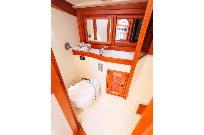 Slide: The Image of Compact bathroom in 1999 Tartan 3500 yacht with wooden accents and modern fixtures. - 40