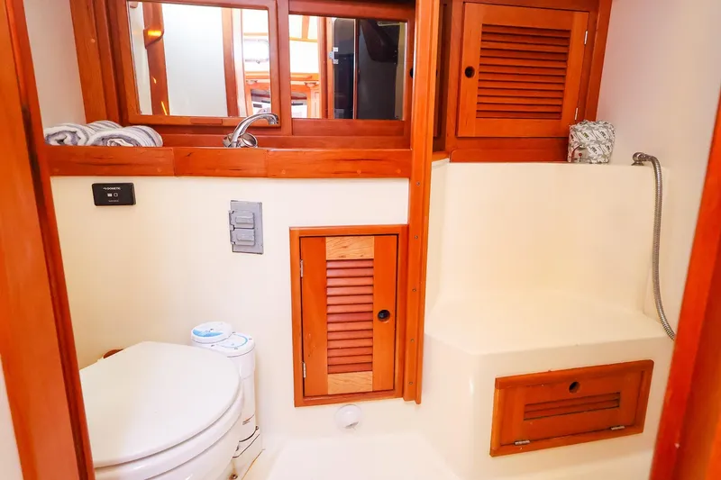 Slide: The Image of 1999 Tartan 3500 yacht bathroom with wooden cabinets and compact fixtures. - 41