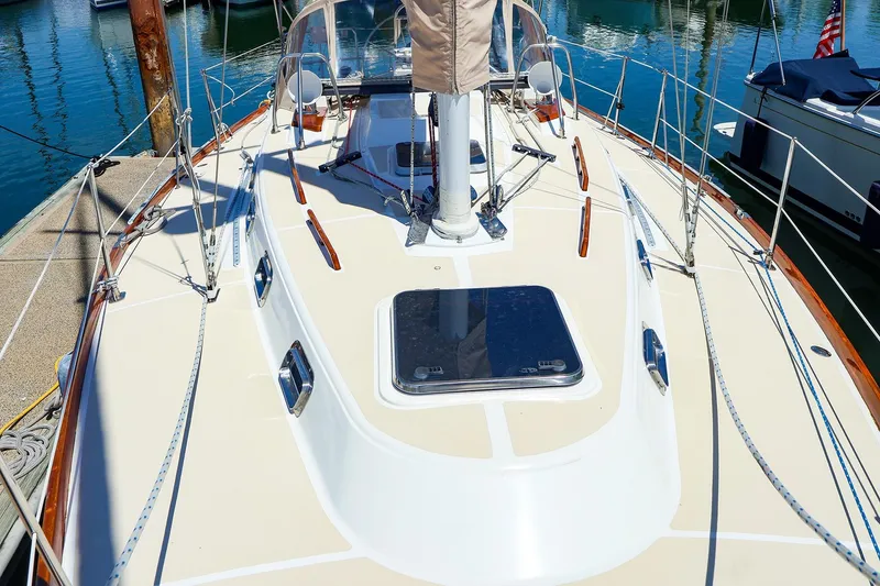 Slide: The Image of Deck view of a 1999 Tartan 3500 sailboat docked at a marina. - 6