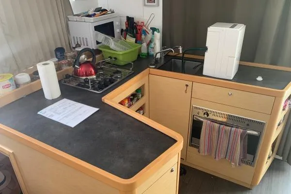 Slide: The Image of Compact kitchen in a 2017 Lagoon 42 catamaran with stove, sink, and appliances. - 10