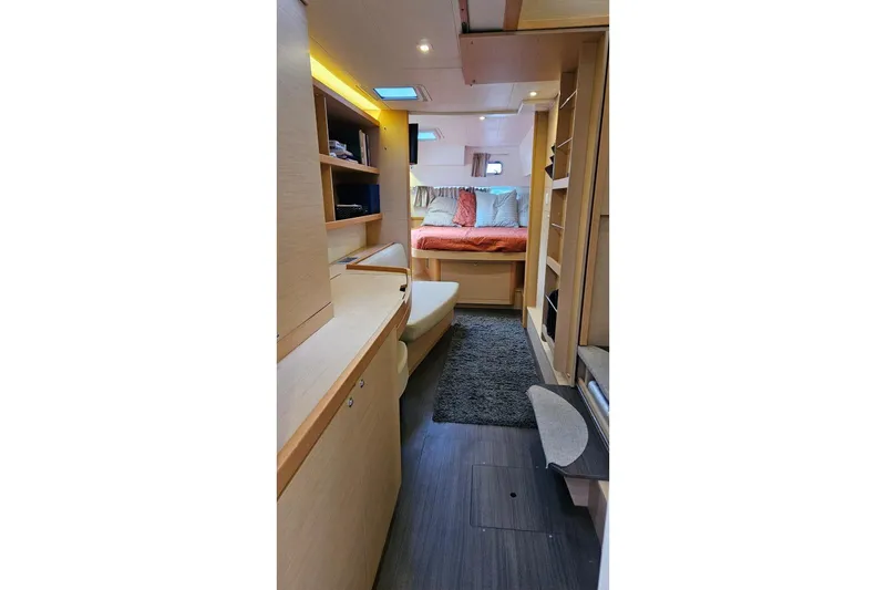 Slide: The Image of Interior of 2017 Lagoon 42 catamaran, featuring cozy cabin with bed and storage. - 13