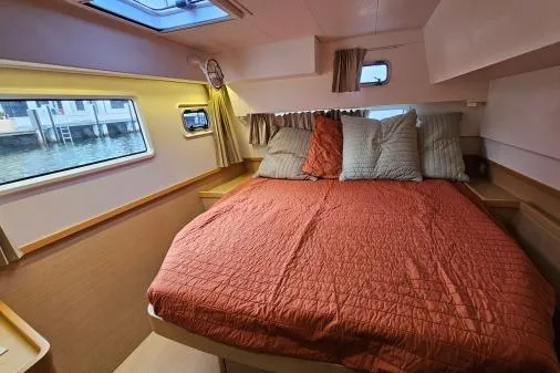 Slide: The Image of Cozy cabin interior of 2017 Lagoon 42 catamaran with a comfortable bed and scenic window view. - 16