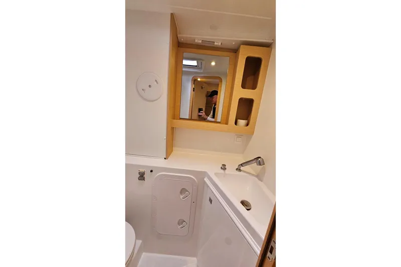 Slide: The Image of Bathroom interior of 2017 Lagoon 42 catamaran with sink and mirror cabinet. - 23
