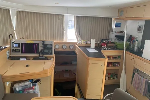 Slide: The Image of Interior of a 2017 Lagoon 42 catamaran with navigation station and kitchen area. - 29