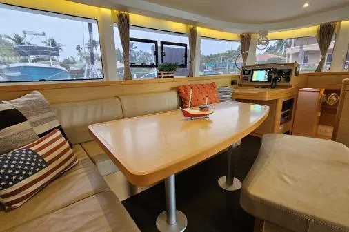 Slide: The Image of Interior of 2017 Lagoon 42 catamaran with cozy seating and navigation equipment. - 5