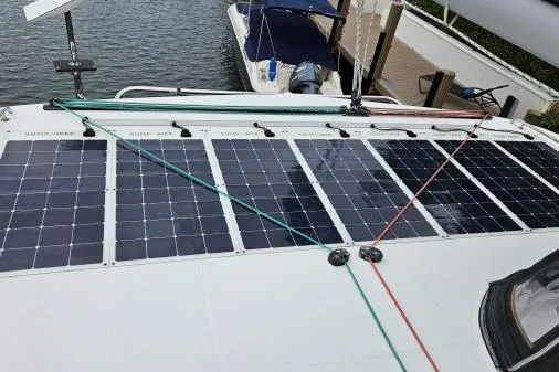 Slide: The Image of 2017 Lagoon 42 catamaran with solar panels on deck, docked at marina. - 56