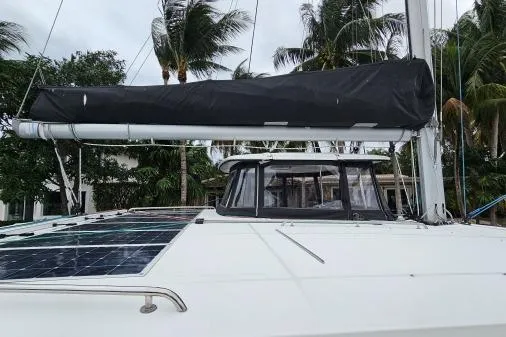 Slide: The Image of 2017 Lagoon 42 catamaran with solar panels, docked near palm trees. - 59