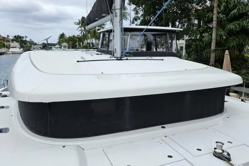 Slide: The Image of 2017 Lagoon 42 catamaran docked, showcasing sleek design and spacious deck. - 60