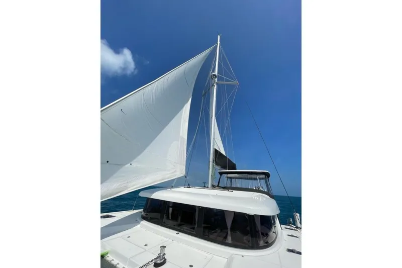 Slide: The Image of Sailing Lagoon 42 catamaran, 2017 model, with white sails against a clear blue sky. - 61