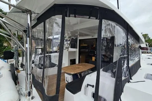 Slide: The Image of 2017 Lagoon 42 catamaran with enclosed cockpit and modern interior design. - 65