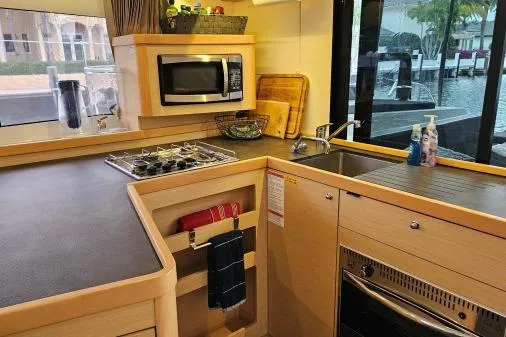 Slide: The Image of Modern kitchen in 2017 Lagoon 42 yacht with stove, microwave, and sink. - 7