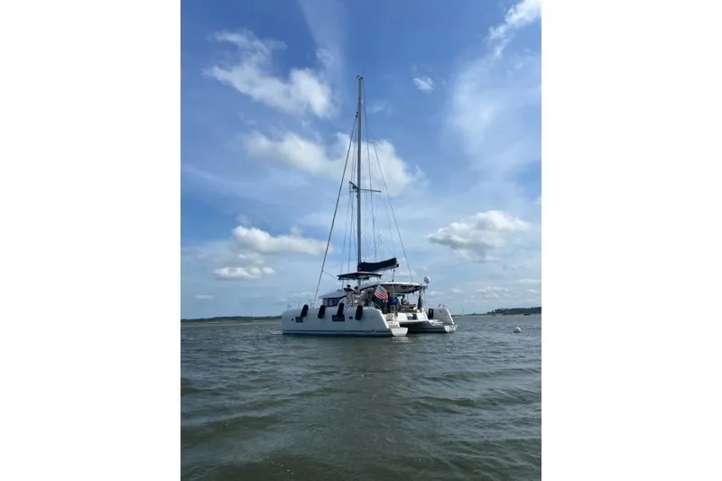 Slide: The Image of 2017 Lagoon 42 catamaran sailing on calm waters under a clear blue sky. - 77
