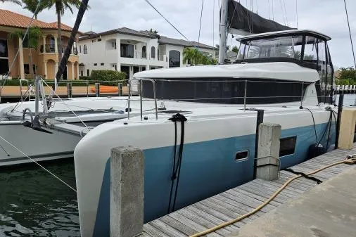 Slide: The Image of 2017 Lagoon 42 catamaran docked near waterfront homes. - 78