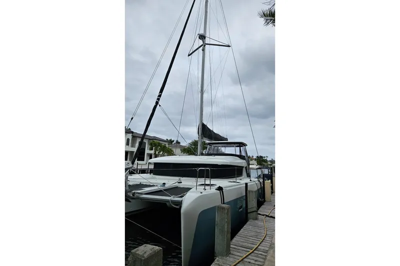 Slide: The Image of 2017 Lagoon 42 catamaran docked, showcasing sleek design and modern features. - 79