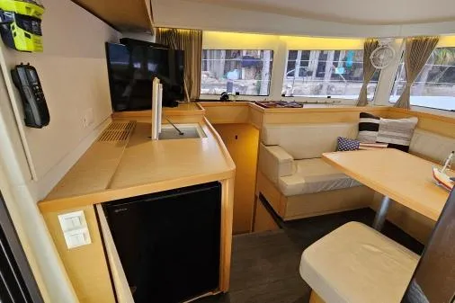 Slide: The Image of Interior of 2017 Lagoon 42 catamaran, featuring modern kitchen and cozy seating area. - 8