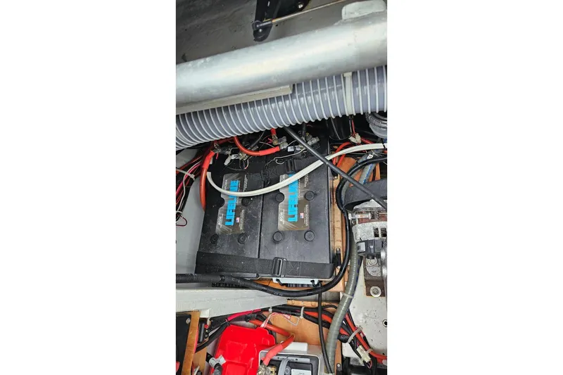 Slide: The Image of Engine compartment of a 2017 Lagoon 42 catamaran, showcasing mechanical components and wiring. - 88