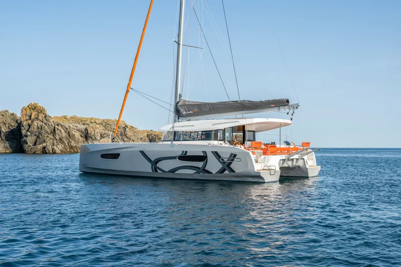 Slide: The Image of Excess EXCESS 14 catamaran 2026 on calm waters. - 2