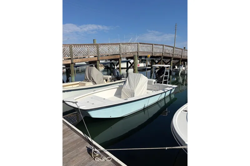 The Image of 2007 Intruder 198 boat docked at marina under clear blue sky. - 0