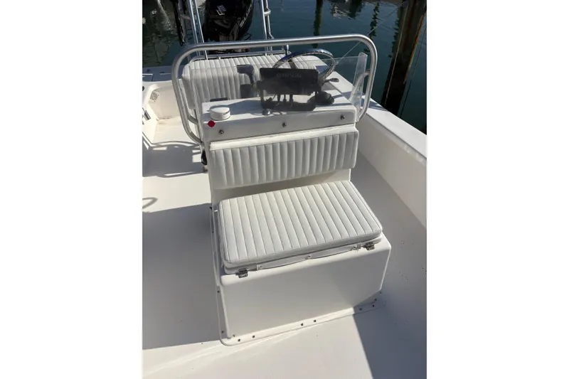 Slide: The Image of 2007 Intruder 198 boat interior with white cushioned seating and steering console. - 12