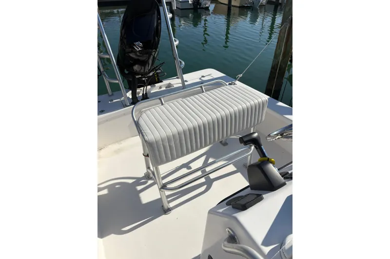 Slide: The Image of 2007 Intruder 198 boat with cushioned seat and motor at dock. - 6