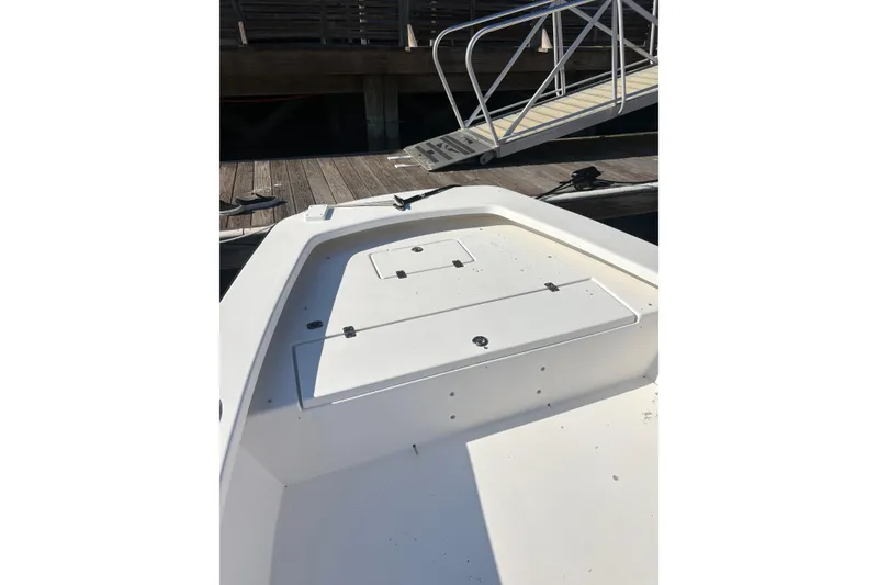 Slide: The Image of 2007 Intruder 198 boat deck near dock with metal railing. - 9