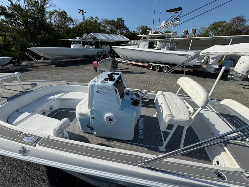 Slide: The Image of 2024 Contender 26 Bay boat with sleek design, spacious seating, and modern controls. - 10