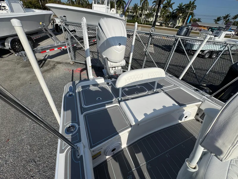 Slide: The Image of 2024 Contender 26 Bay boat with sleek deck design and powerful outboard motor. - 19