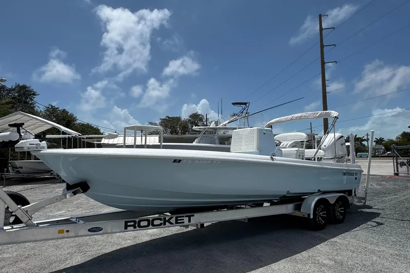 Slide: The Image of 2024 Contender 26 Bay boat on a Rocket trailer under a clear blue sky. - 3
