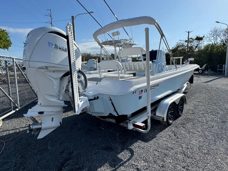 Slide: The Image of 2024 Contender 26 Bay boat with Yamaha outboard engine on a trailer. - 4