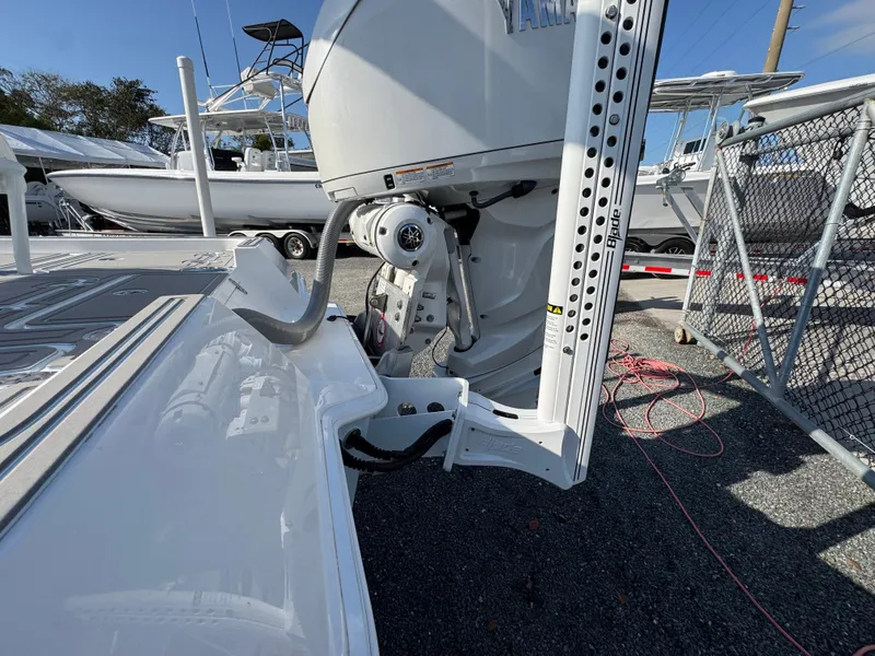 Slide: The Image of 2024 Contender 26 Bay boat with Yamaha outboard motor, docked in a marina. - 7