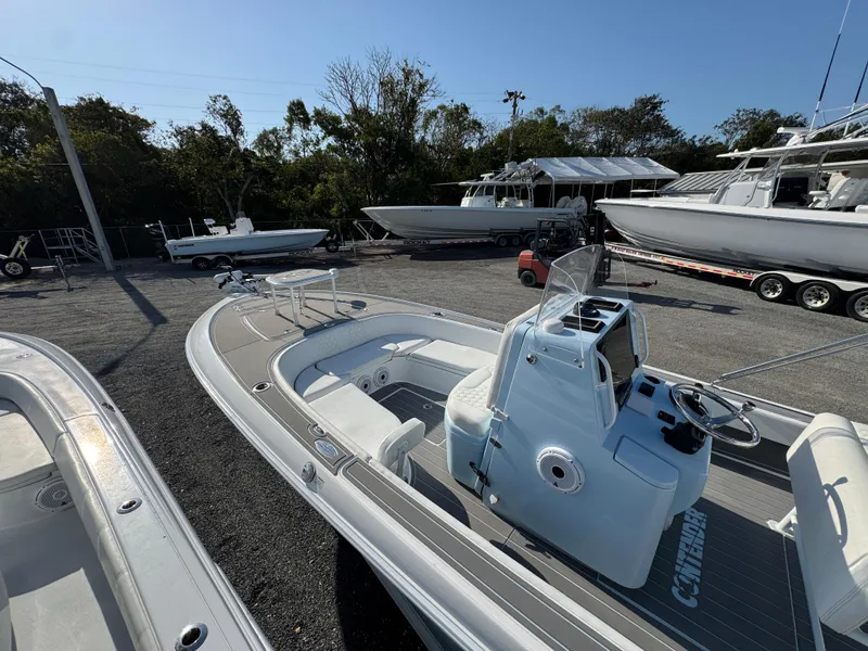 Slide: The Image of 2024 Contender 26 Bay boat in a marina, surrounded by other vessels. - 9