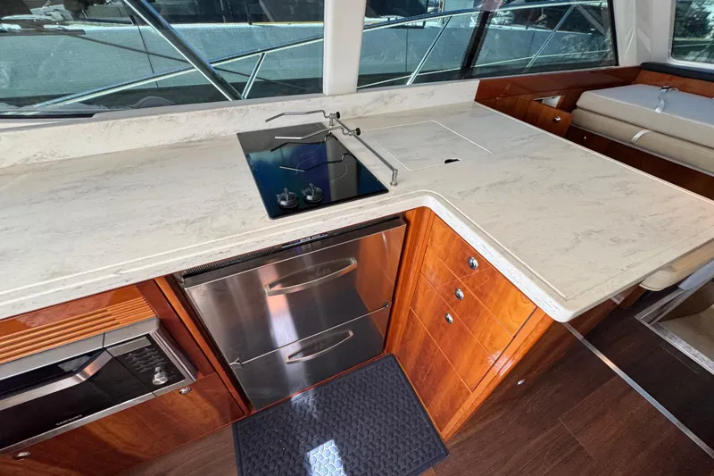 Slide: The Image of Luxurious 2016 Riviera 43 Open Flybridge yacht kitchen with modern appliances and sleek design. - 10